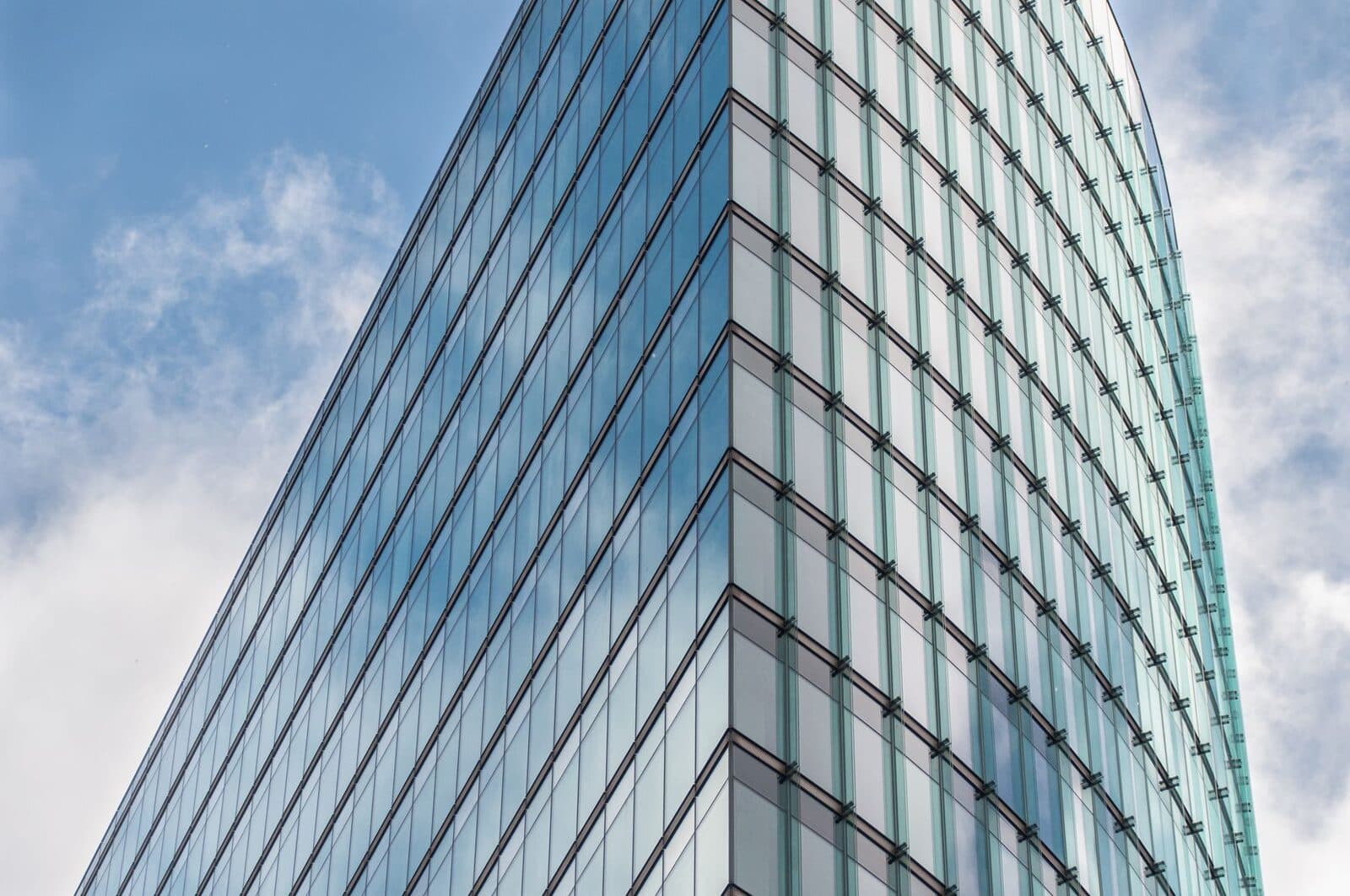 A modern corporate office tower clad in glass