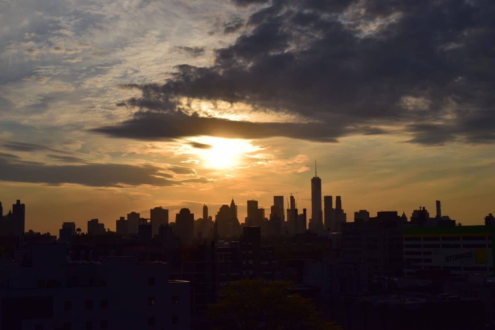 A warm sunset glowing over a city skyline