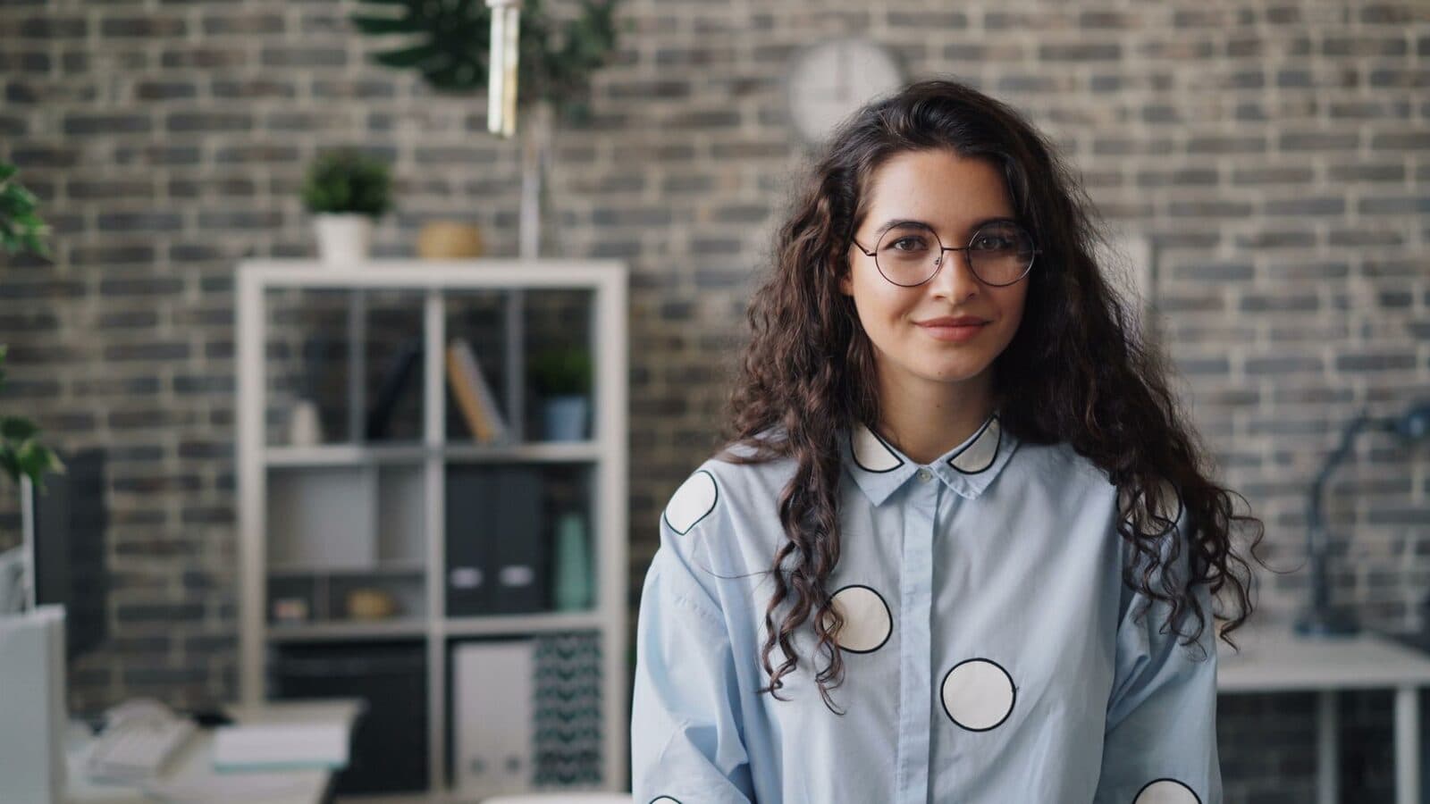 A confident professional standing in a bright office