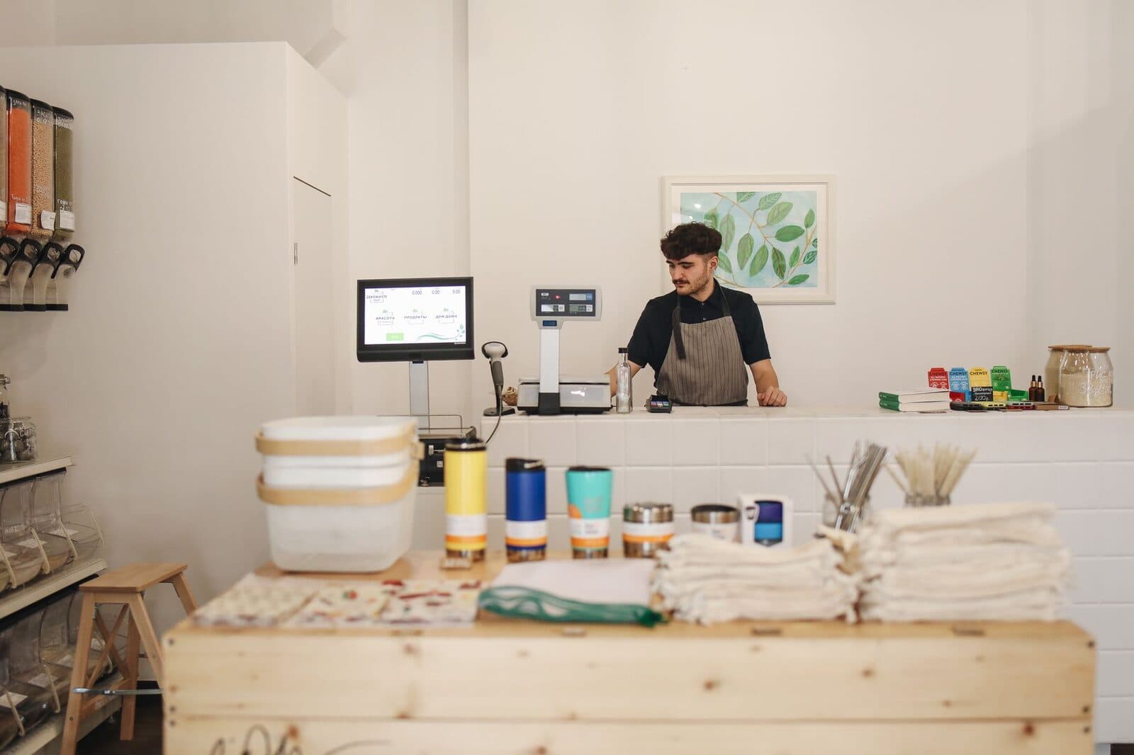A small-business owner behind the counter of their shop